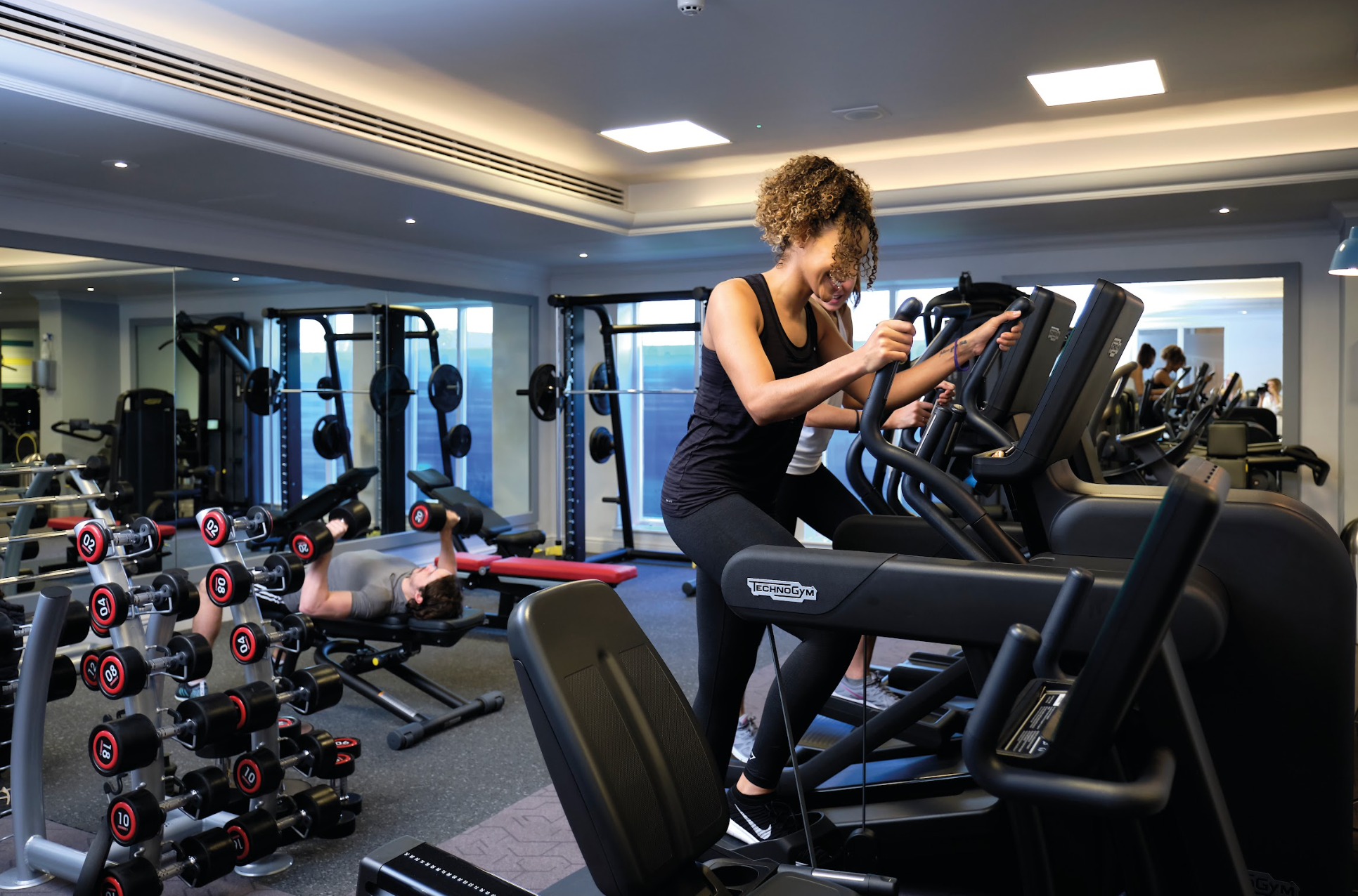 Women exercising on an elliptical machine